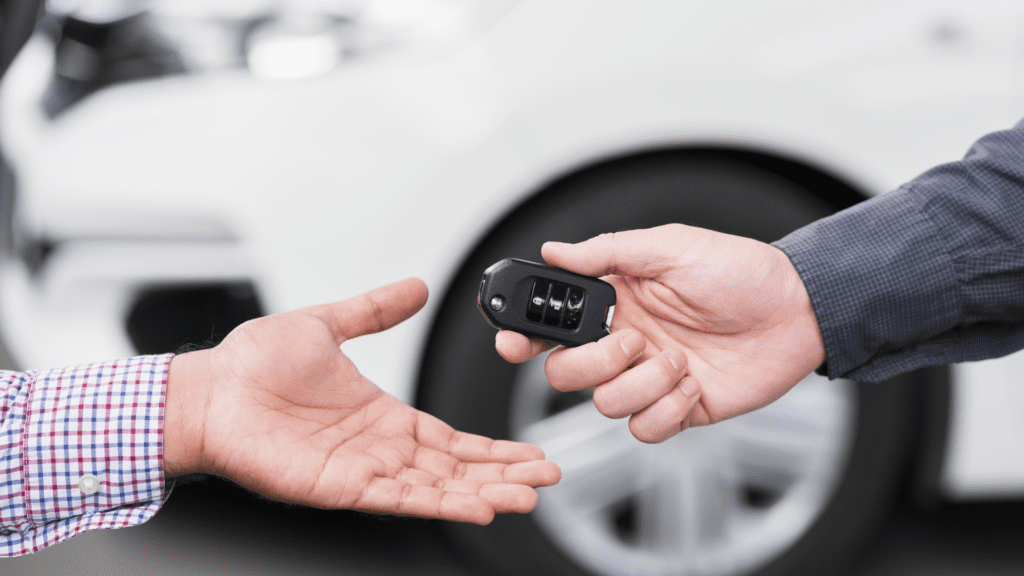 handing over keys for new vehicle purchase